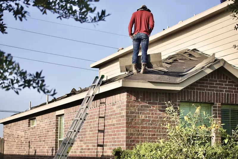 Professional roofer working on a residential roof in Sunset Manor